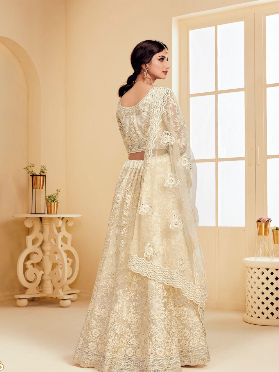 Ethereal Off-White Soft Net Party Wear Lehenga with Heavy Stone & Coding Work
